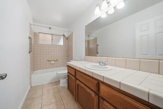 a view of a room with wooden floor and a ceiling fan
