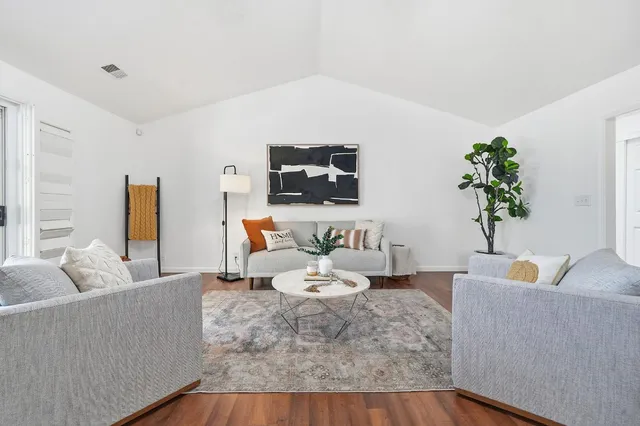 a living room with furniture and a potted plant