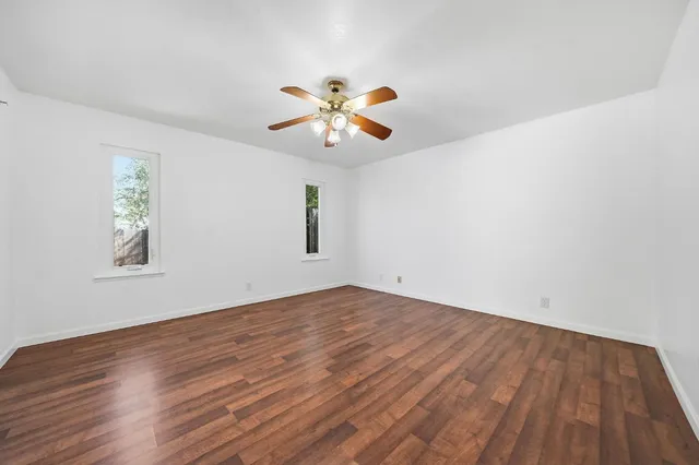 a view of a patio with table and chairs with wooden floor and fence