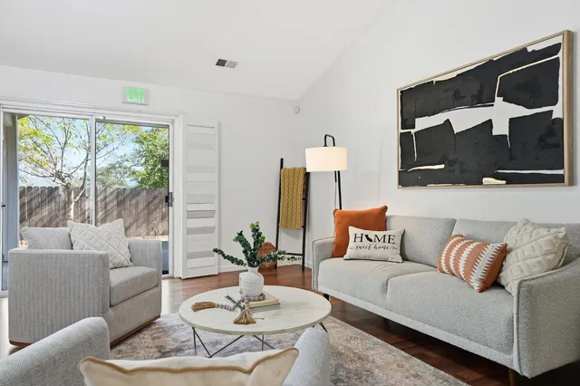 a living room with furniture and a floor to ceiling window