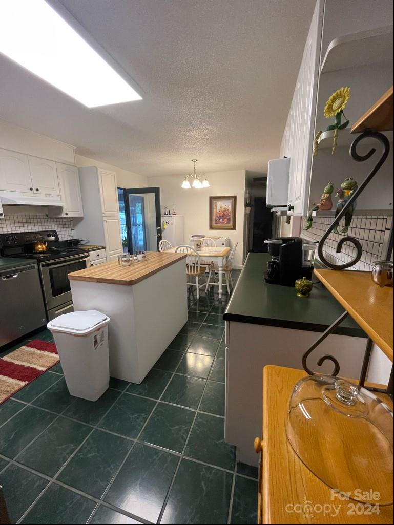 313 Summers Road Morganton, NC 28655 - Photo 13 of 36 a large kitchen with a sink stainless steel appliances and cabinets