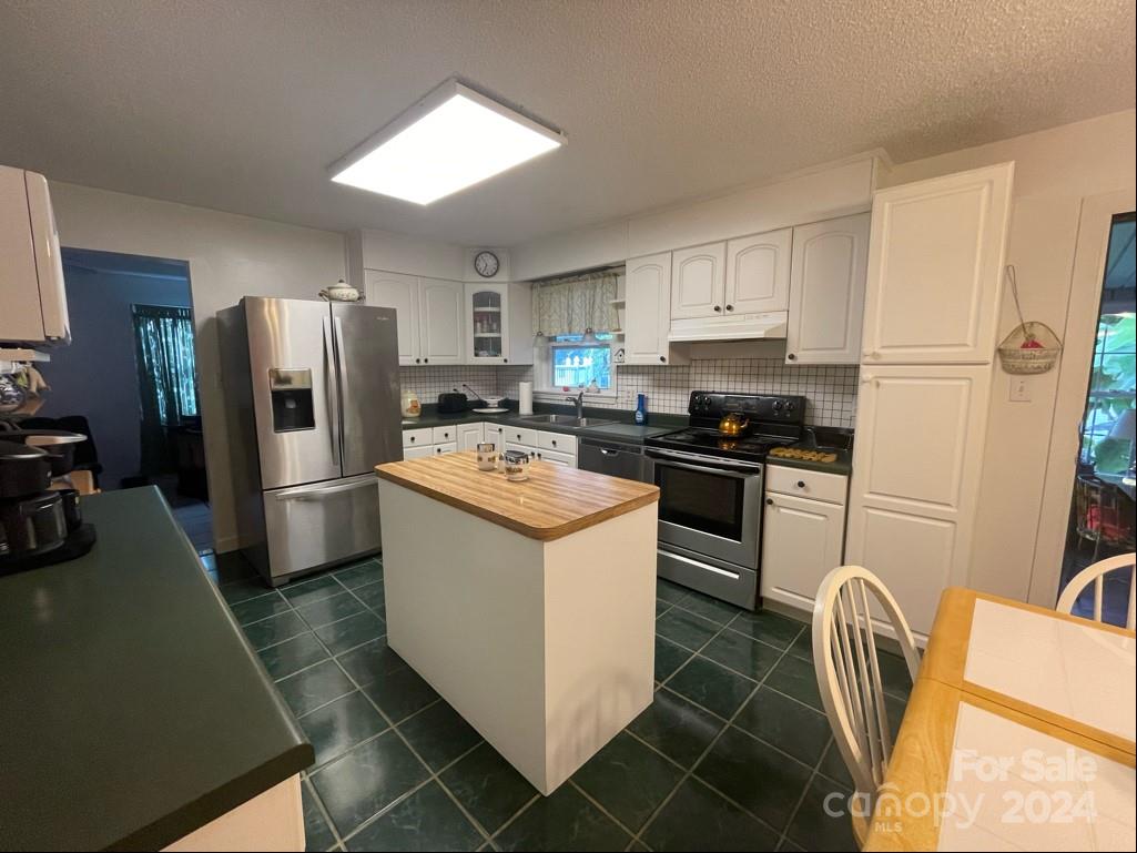 313 Summers Road Morganton, NC 28655 - Photo 14 of 36 a kitchen with stainless steel appliances a refrigerator stove and sink