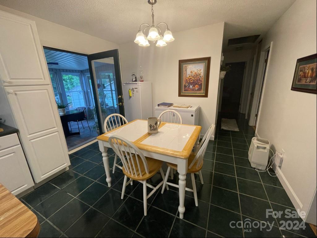 313 Summers Road Morganton, NC 28655 - Photo 16 of 36 a view of a dining room with furniture and wooden floor