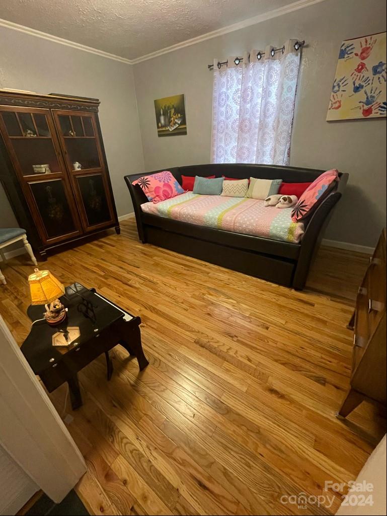 313 Summers Road Morganton, NC 28655 - Photo 18 of 36 a bedroom with a bed and wooden floor