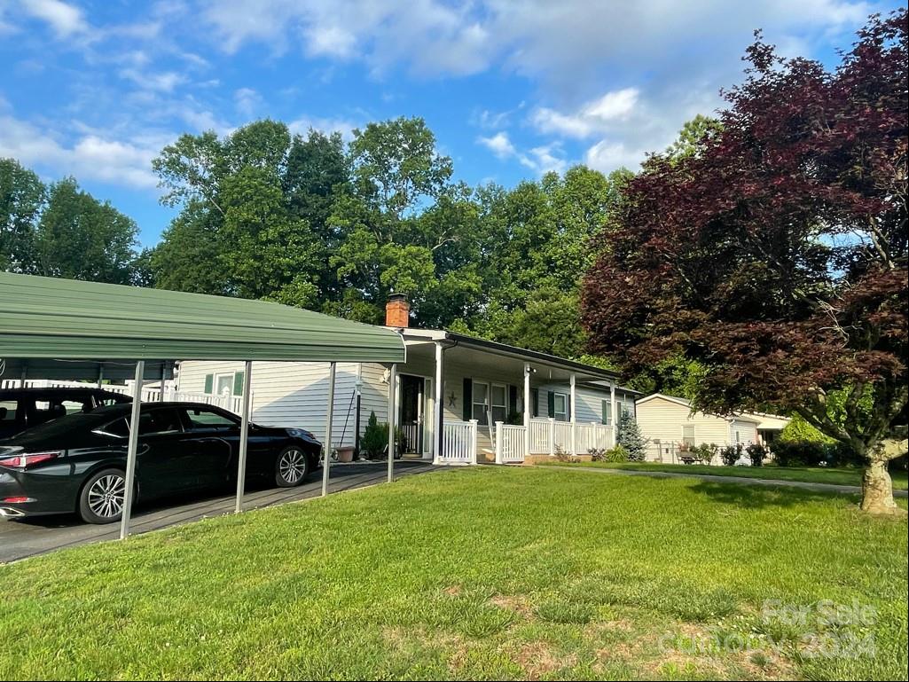 313 Summers Road Morganton, NC 28655 - Photo 2 of 36 a view of a yard with table and chairs under an umbrella