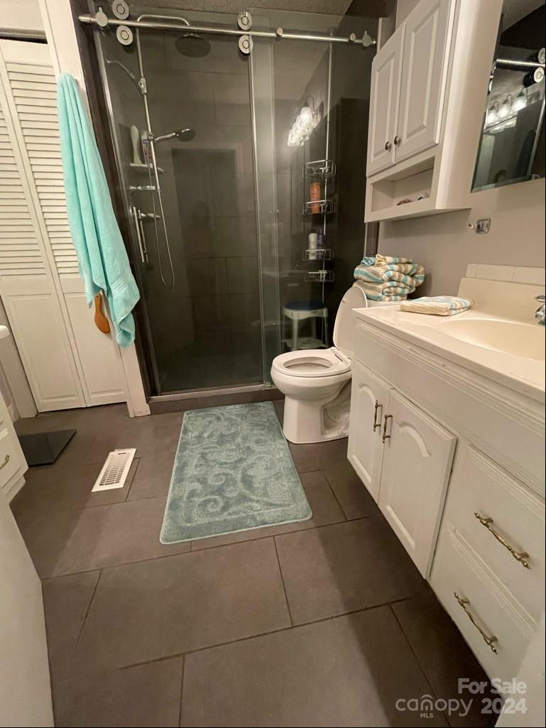 313 Summers Road Morganton, NC 28655 - Photo 22 of 36 a bathroom with a sink a toilet and shower