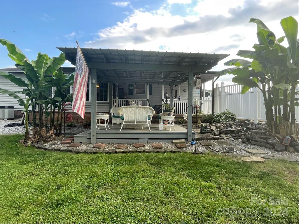 313 Summers Road Morganton, NC 28655 - Photo 26 of 36 a view of a house with backyard sitting area and garden