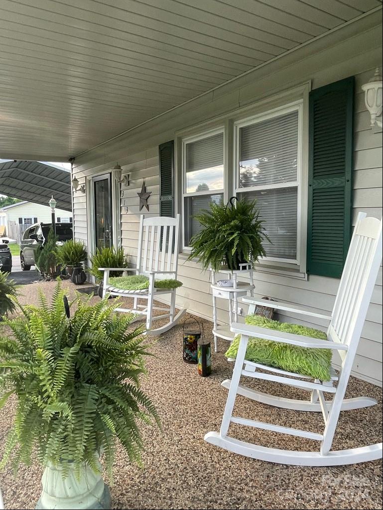 313 Summers Road Morganton, NC 28655 - Photo 7 of 36 a view of a patio with table and chairs potted plants and large tree