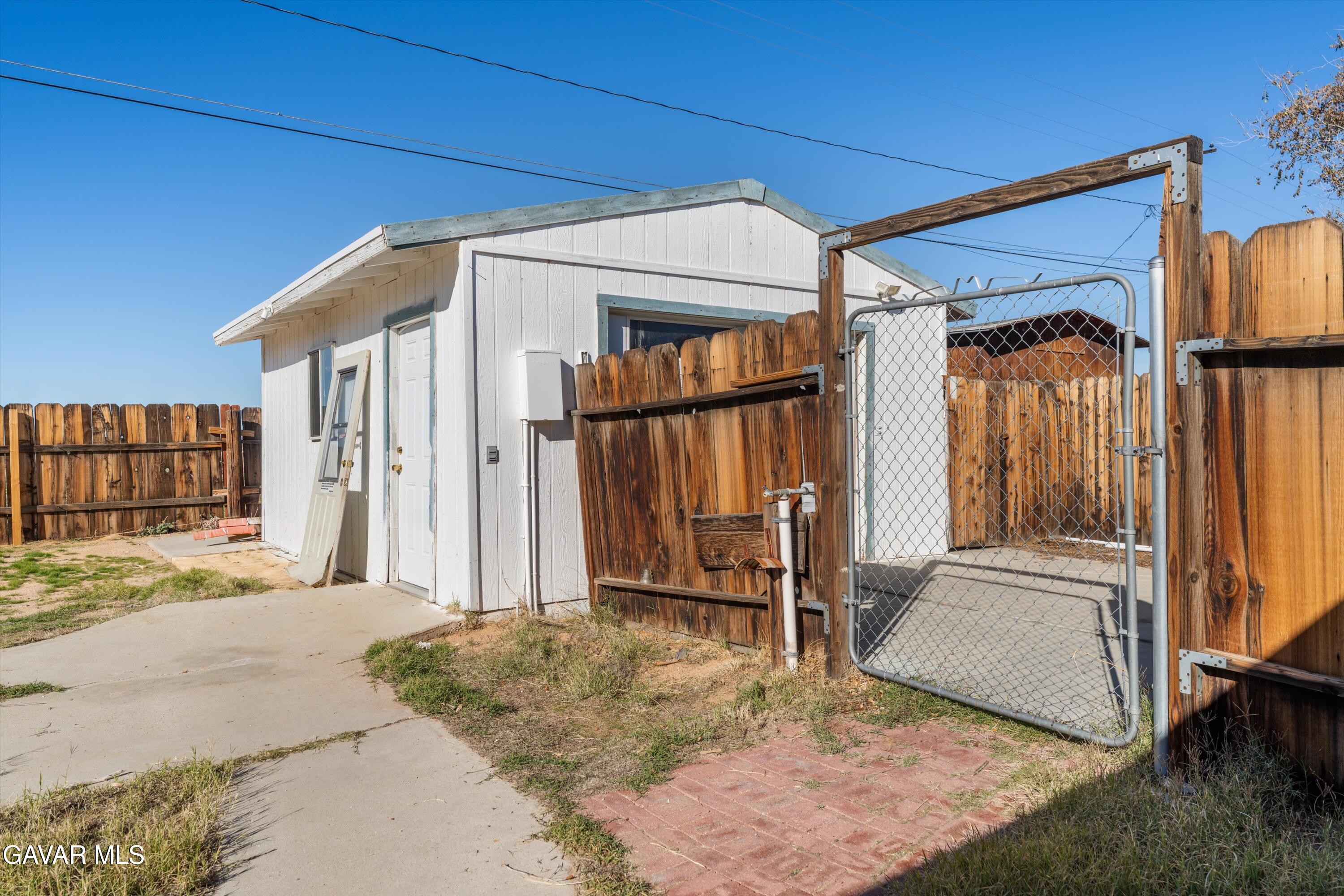 13445 Fran Street North Edwards, CA 93523 - Photo 13 of 27 a view of a house with a door and wooden walls