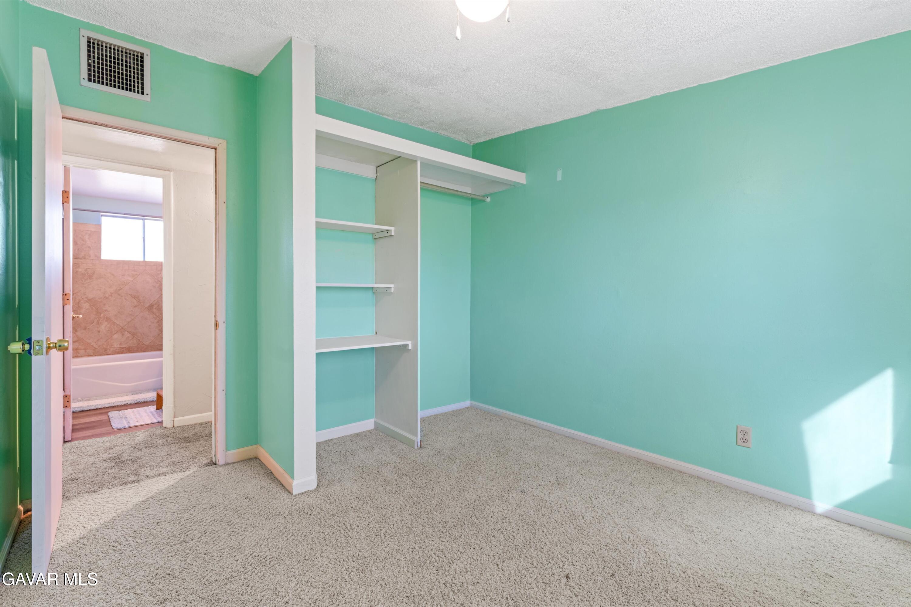 13445 Fran Street North Edwards, CA 93523 - Photo 16 of 27 a view of an empty room with closet and a kitchen