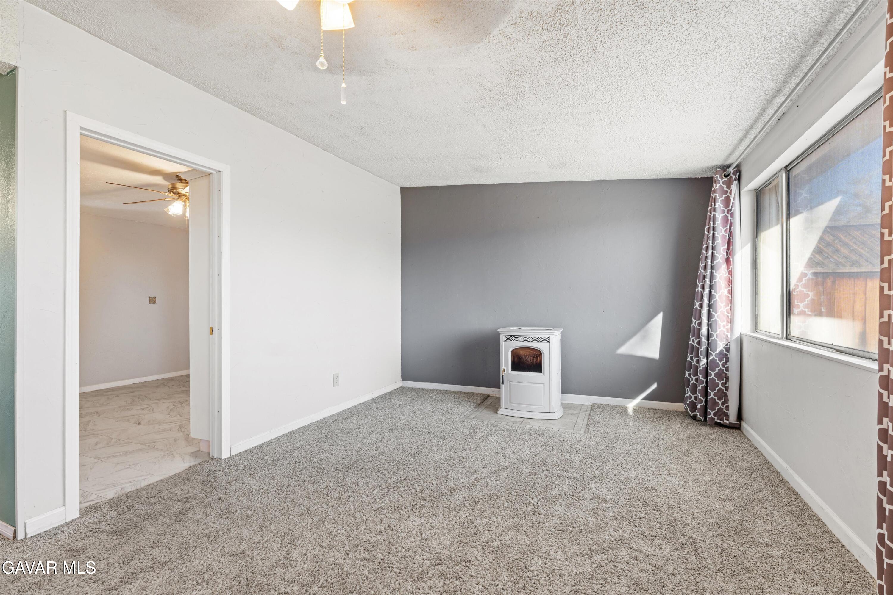 13445 Fran Street North Edwards, CA 93523 - Photo 5 of 27 an empty room with windows and cabinet