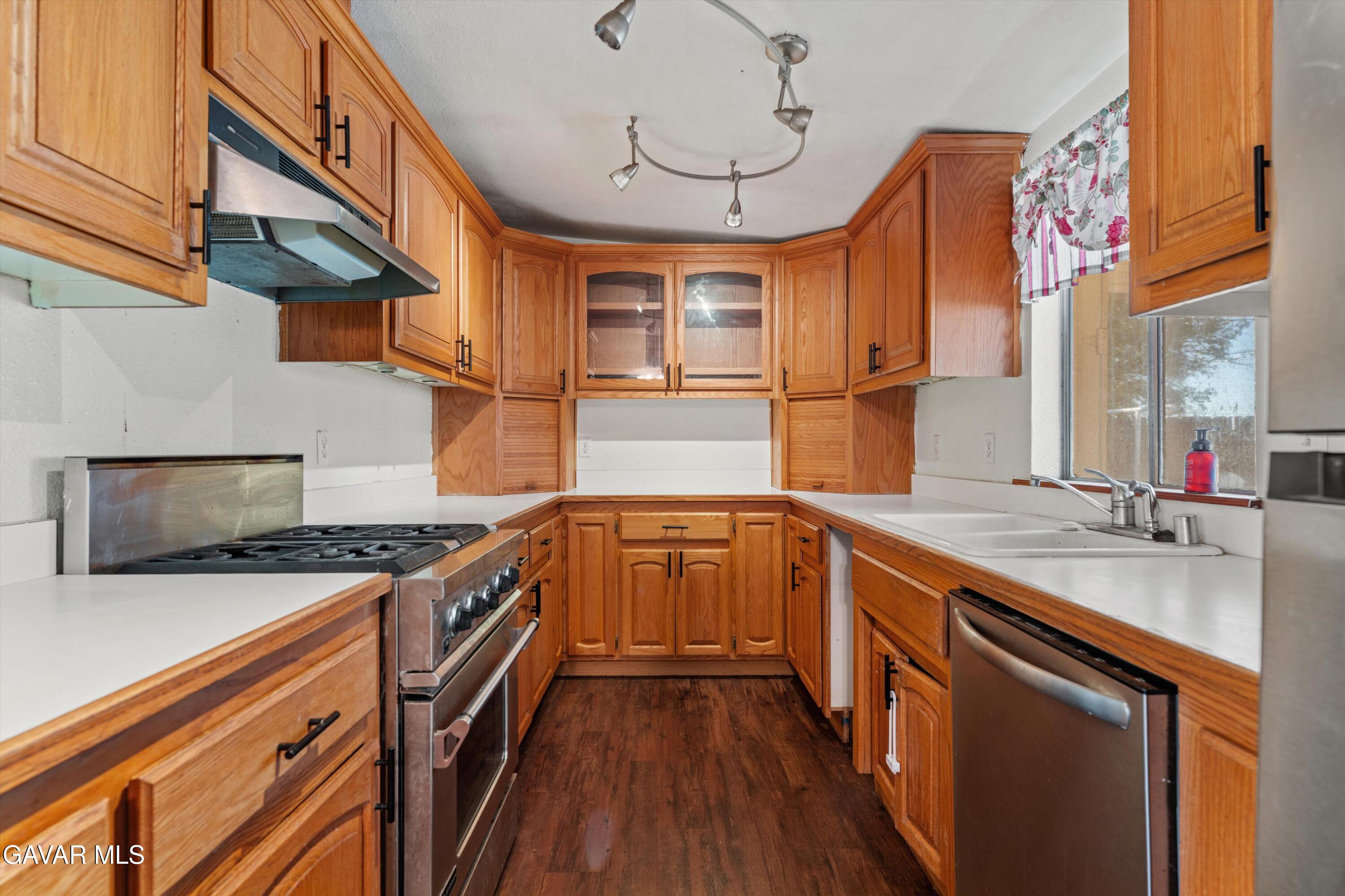 13445 Fran Street North Edwards, CA 93523 - Photo 7 of 27 a kitchen with stainless steel appliances granite countertop a sink stove and cabinets