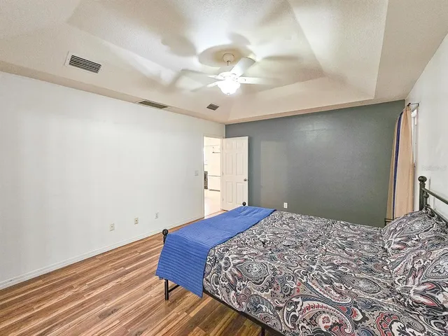 a bedroom with a bed and a chandelier
