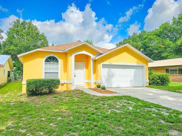 a front view of house with yard and green space