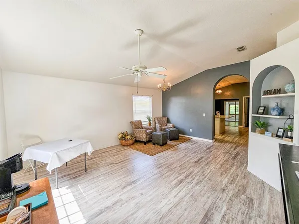 a living room with furniture and a chandelier