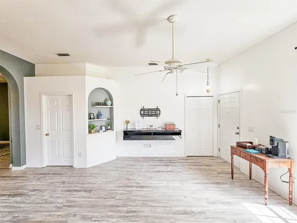a living room with furniture and a wooden floor