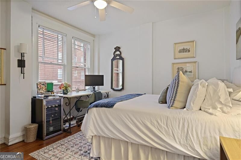 734 Highland Avenue Northeast, Unit 2 Atlanta, GA 30312 - Photo 10 of 24 Bedroom featuring dark wood finished floors, wine cooler, a ceiling fan, and a desk