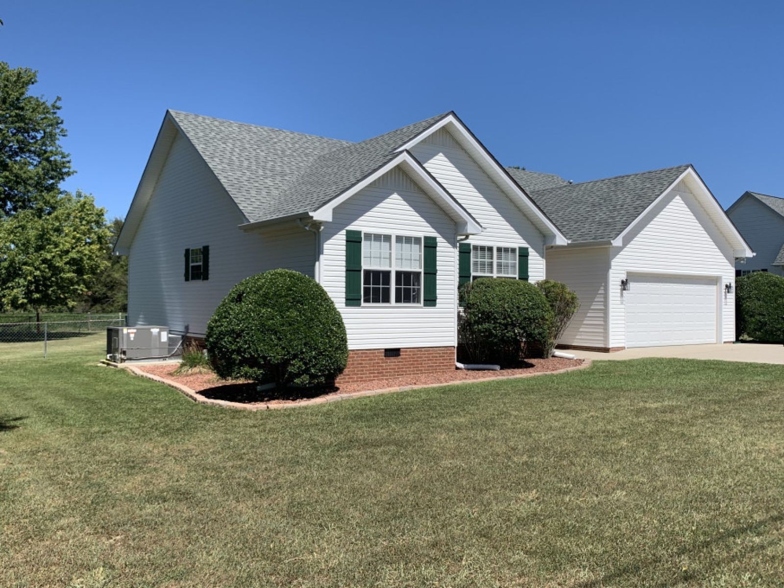 59 Falcon Drive Manchester, TN 37355 - Photo 2 of 20 a front view of a house with a yard and garage