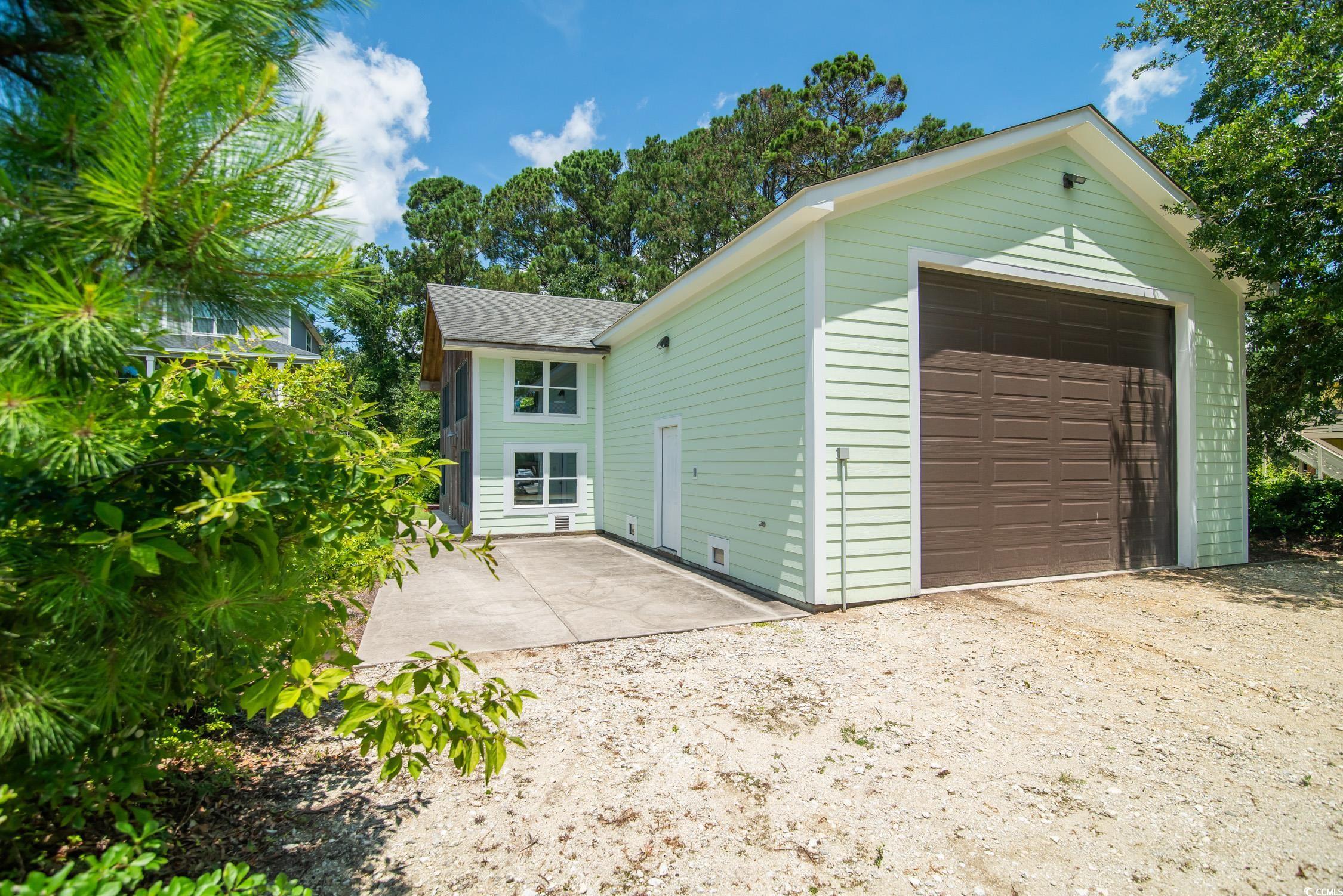 127 Brown Pelican Loop Pawleys Island, SC 29585 - Photo 2 of 31 Garage with dirt driveway