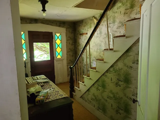 a room with a wooden floor and a window