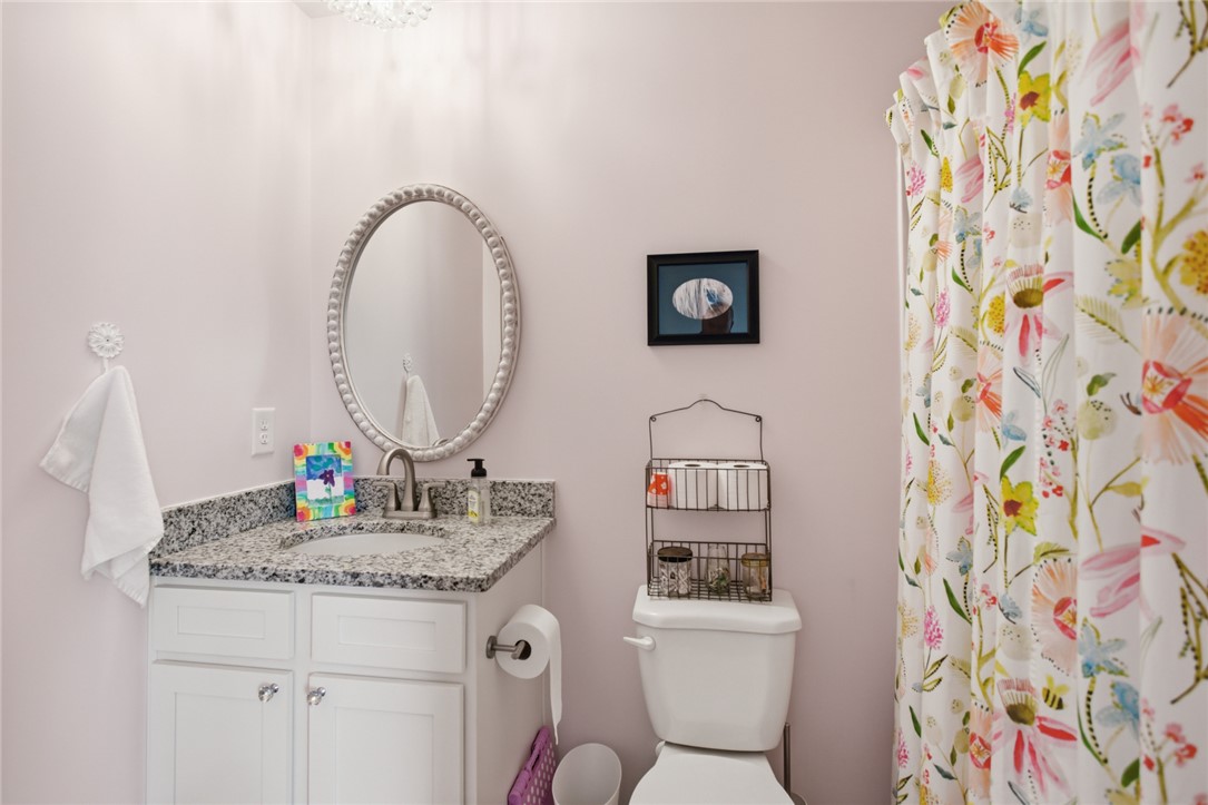 412 Chadwick Lane Walhalla, SC 29691 - Photo 20 of 37 This powder room features a granite-topped vanity and an elegant oval mirror.