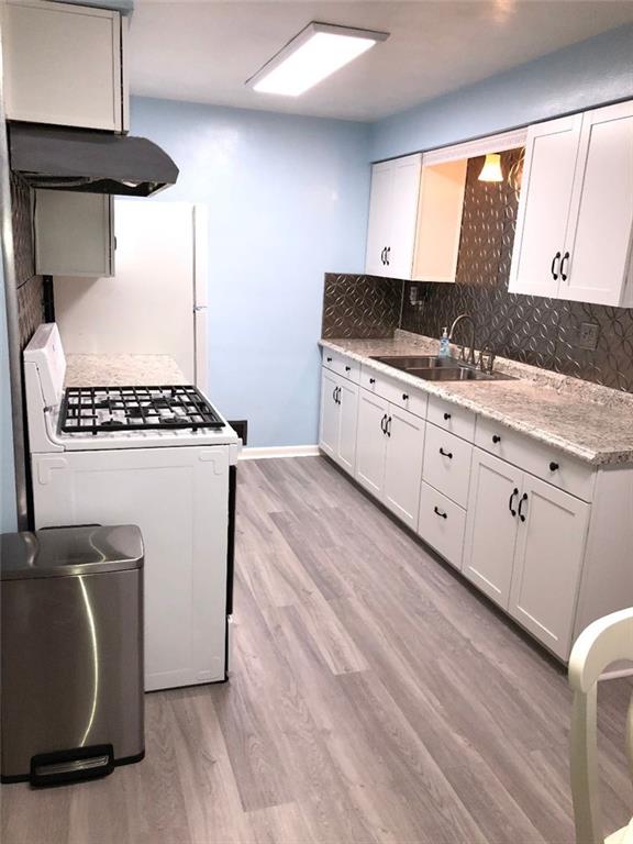 Brand New Kitchen (from the ground up, completely remodeled).  Beautiful backsplash, new skylight bright-lights installed, brand new floor.
