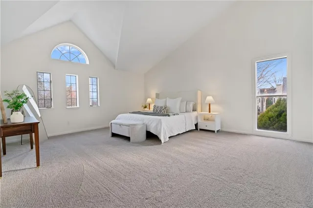 a spacious bedroom with a bed and a window