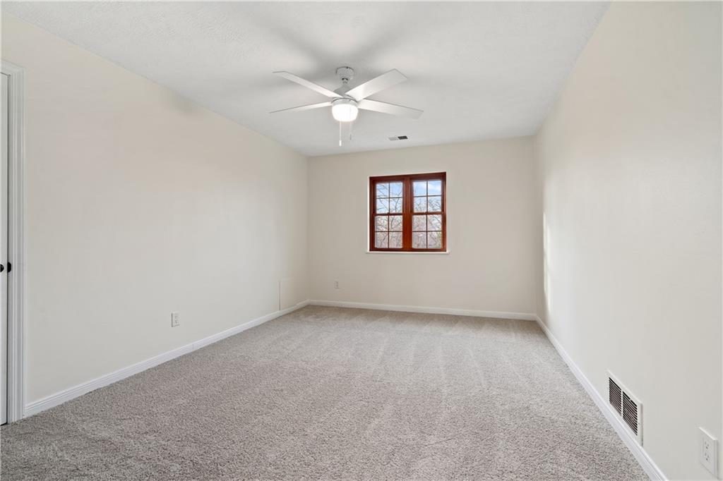 4636 Brownsville Road Pittsburgh, PA 15236 - Photo 22 of 40 an empty room with windows and fan