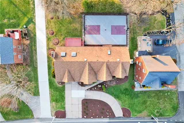 an aerial view of a house with a garden and a car park