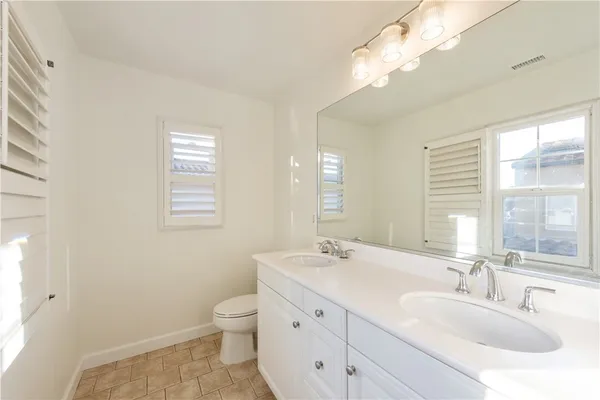 a bathroom with a double vanity sink and a mirror