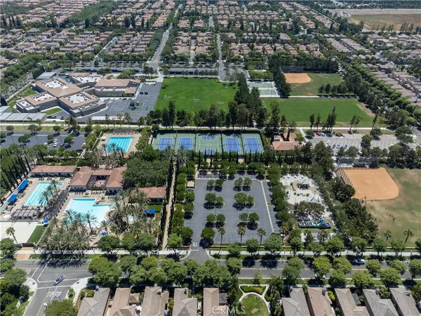 an aerial view of a house with a swimming pool and outdoor seating