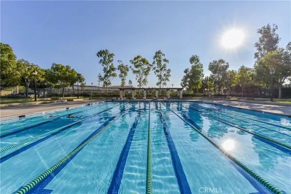 a swimming pool with outdoor seating and yard