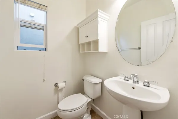 a bathroom with a sink a mirror and a toilet