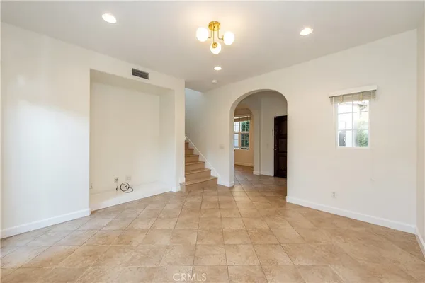 a view of an empty room with closet and a window