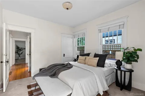 a bedroom with a bed and a potted plant