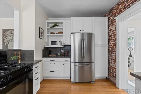 a kitchen with stainless steel appliances a refrigerator stove and microwave