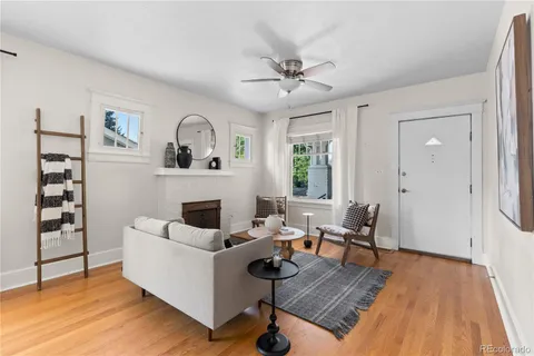 a living room with furniture a rug and a window