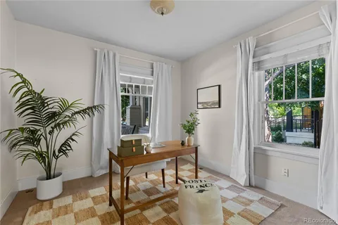 a living room with furniture and a potted plant