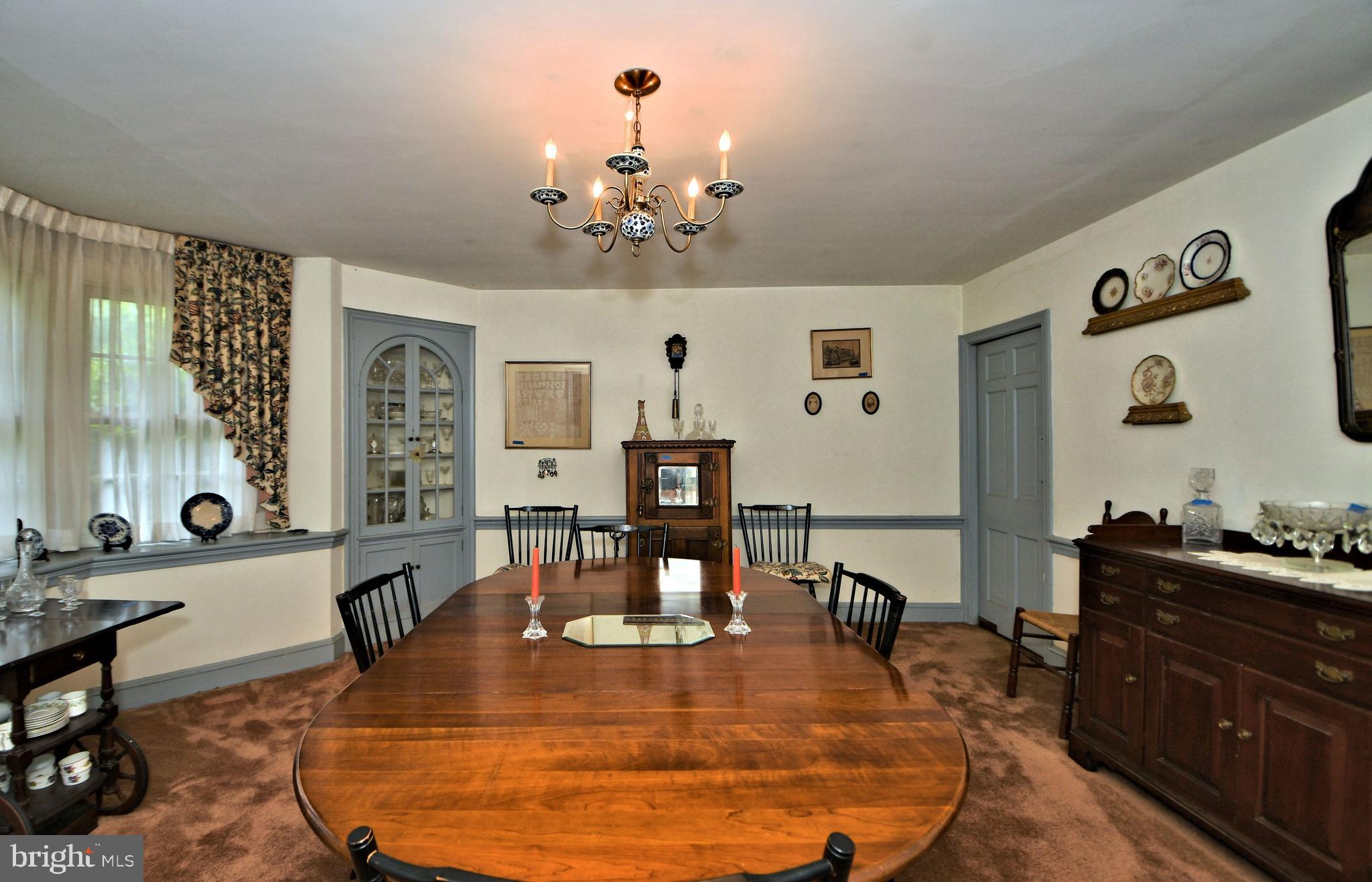 120 Hewett Road Wyncote, PA 19095 - Photo 12 of 44 a dining room with wooden floor a chandelier a wooden table and chairs