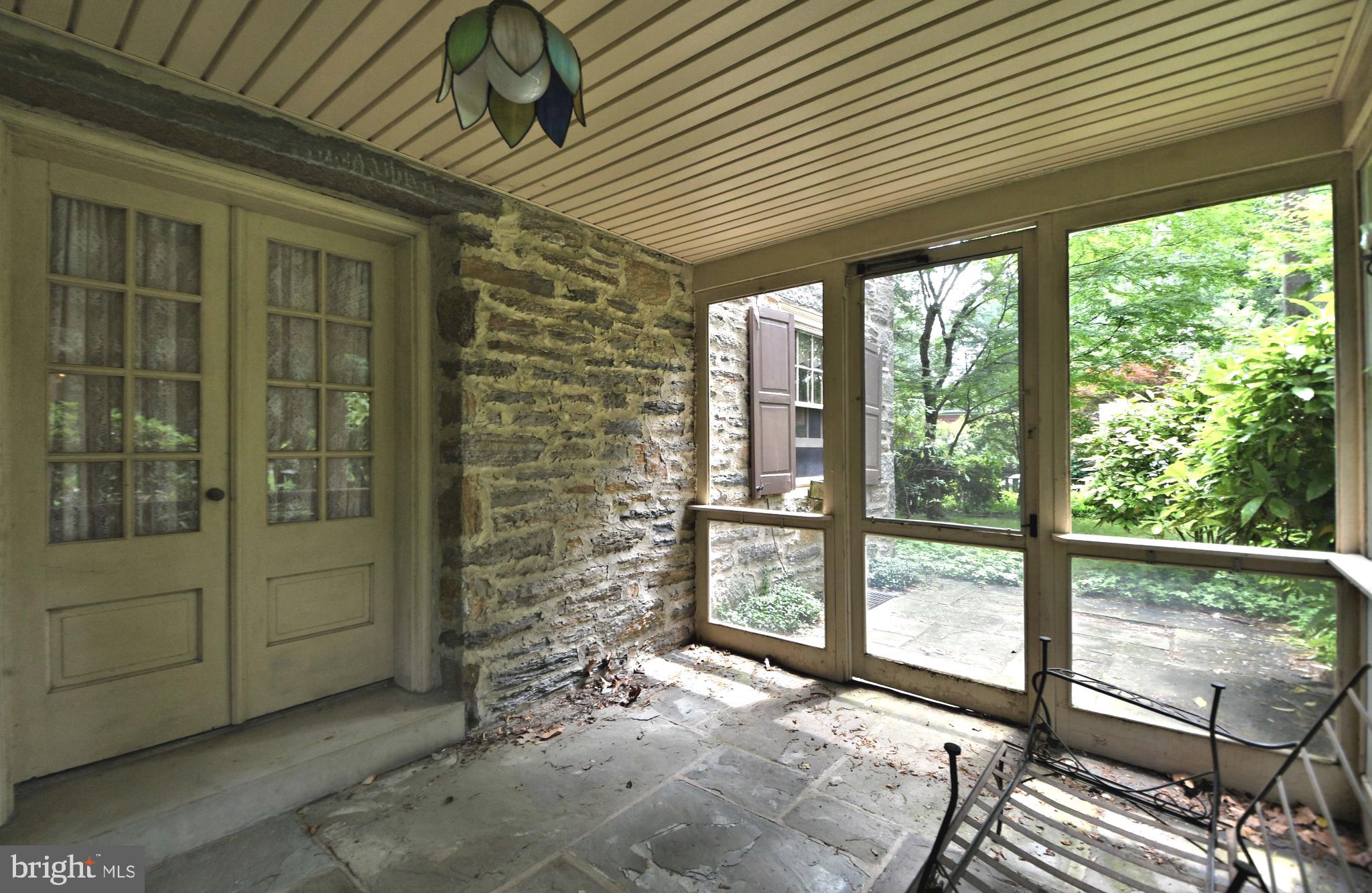 120 Hewett Road Wyncote, PA 19095 - Photo 37 of 44 a view of a porch with a table and chairs and floor to ceiling window