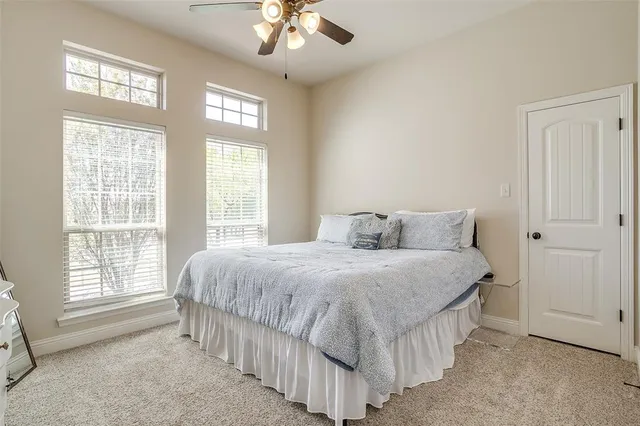 a spacious bedroom with a bed and a window