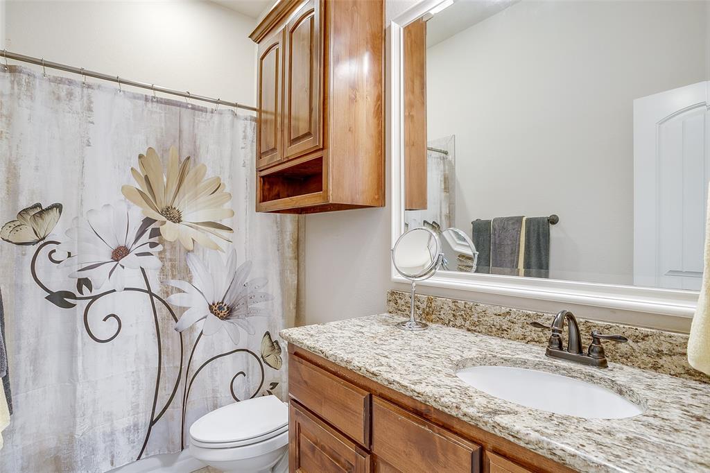 131 Condor View Weatherford, TX 76087 - Photo 22 of 34 a bathroom with a granite countertop sink a toilet and a mirror