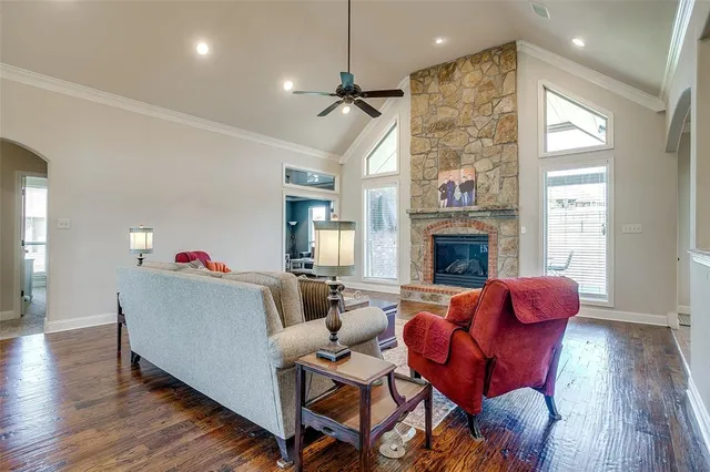 a living room with furniture fireplace and window