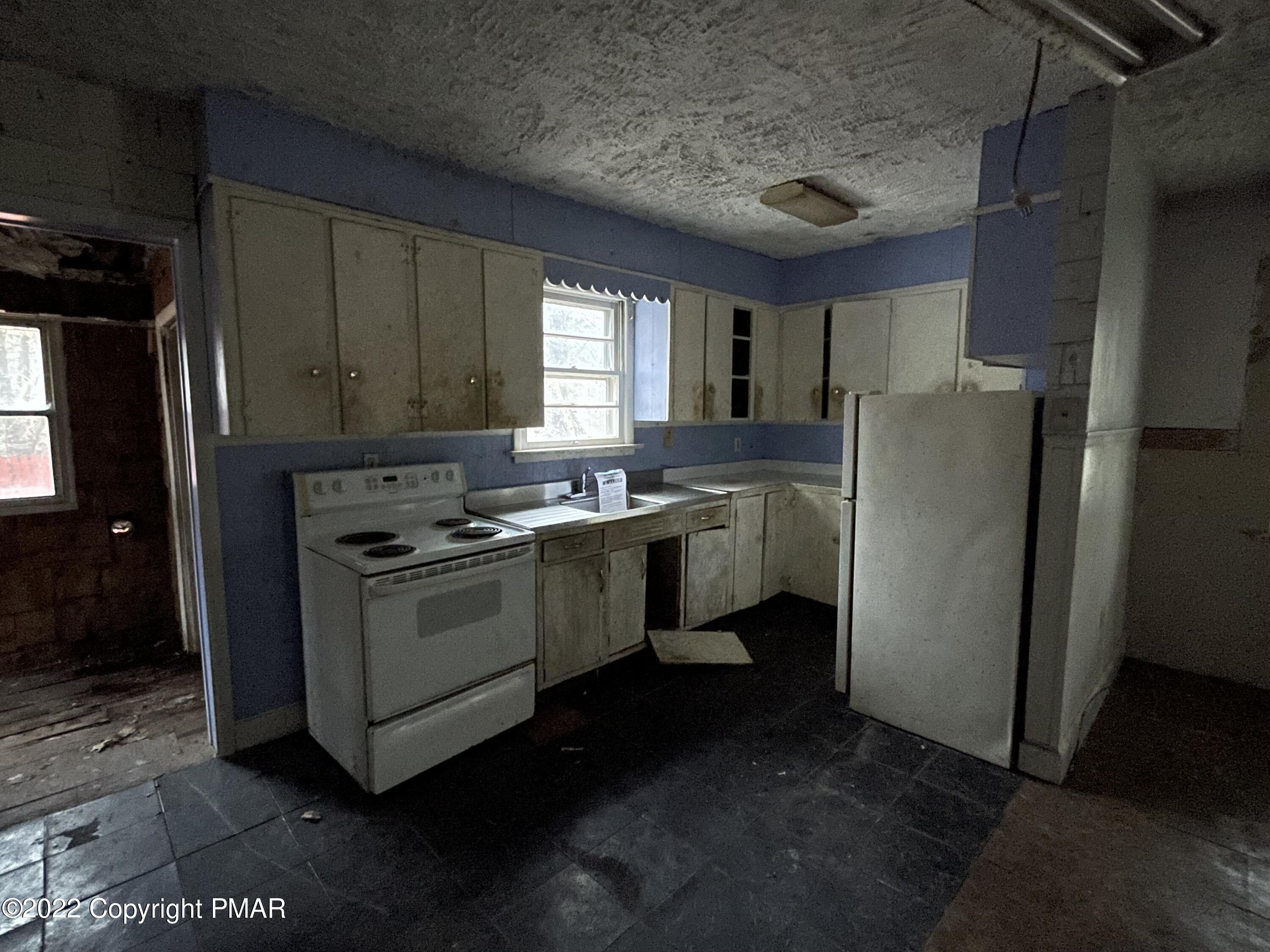 1907 Johns Road Effort, PA 18330 - Photo 3 of 5 a kitchen with sink a refrigerator and cabinets
