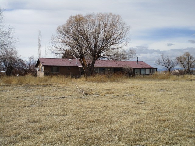 1054-19 19 1/2 Road Fruita, CO 81521 - Photo 18 of 24 a backyard of a house with lots of green space and lake view