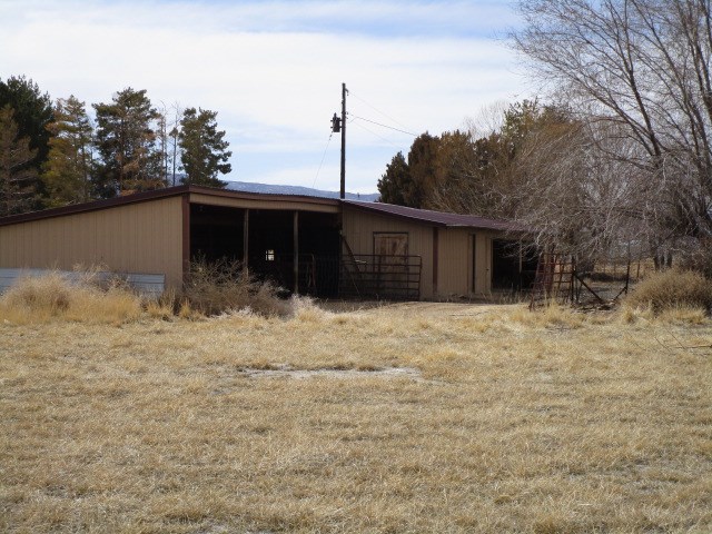 1054-19 19 1/2 Road Fruita, CO 81521 - Photo 19 of 24 a front view of a house with a yard and garage