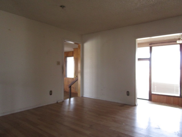 1054-19 19 1/2 Road Fruita, CO 81521 - Photo 4 of 24 an empty room with wooden floor and windows
