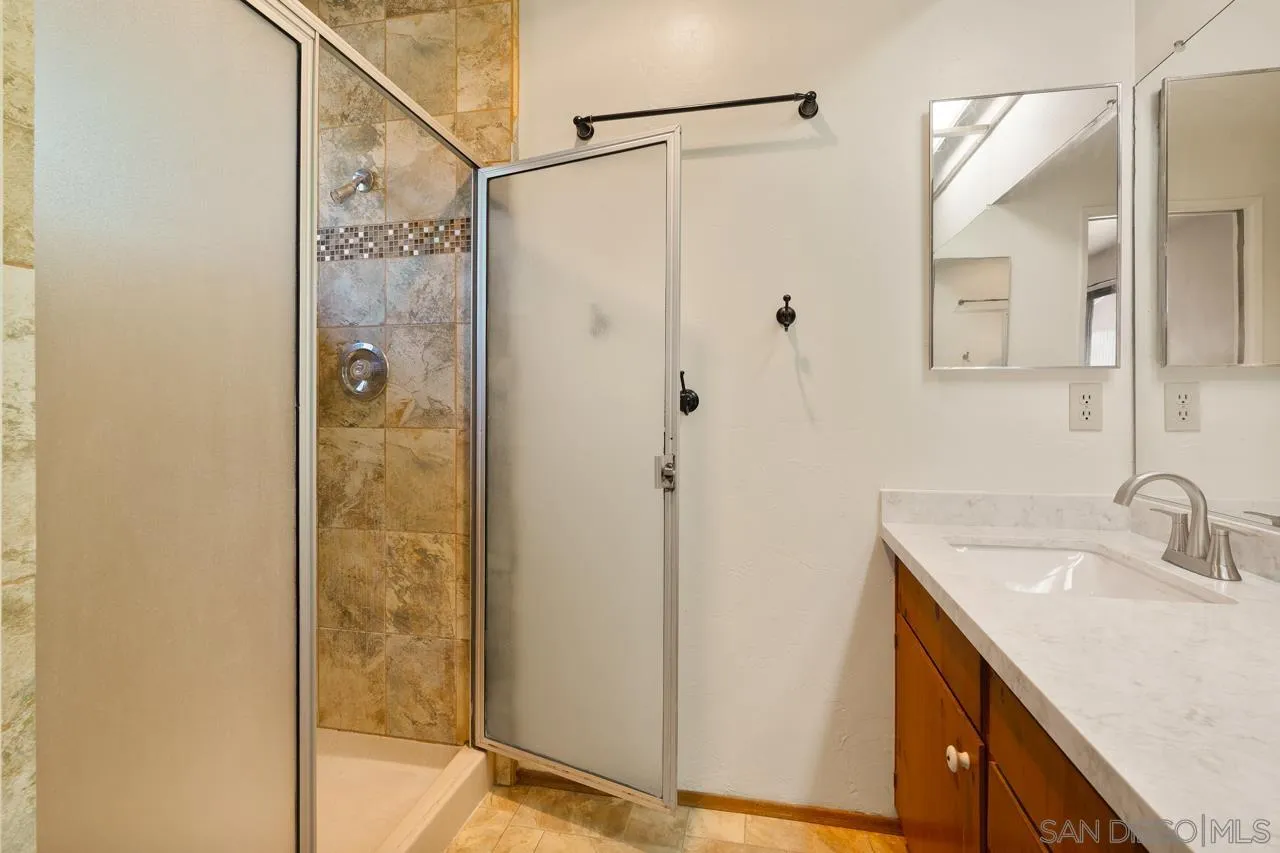 11458 Manzanita Road Lakeside, CA 92040 - Photo 54 of 71 a bathroom with a shower sink and mirror