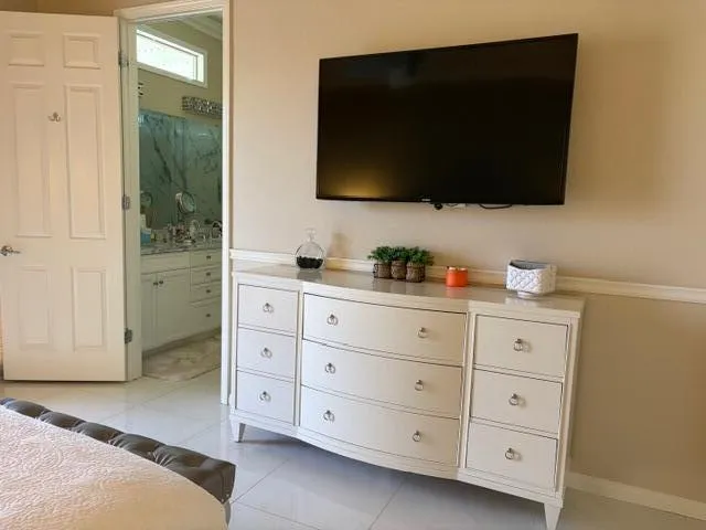 a bathroom with a granite countertop sink a mirror and shower