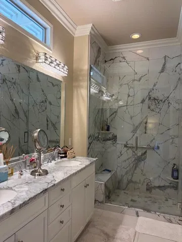 a bathroom with a granite countertop sink toilet and shower
